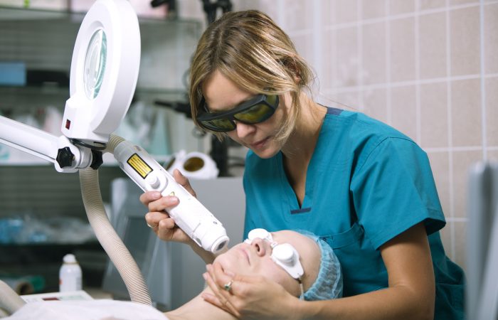 Woman undergoing laser skin treatment